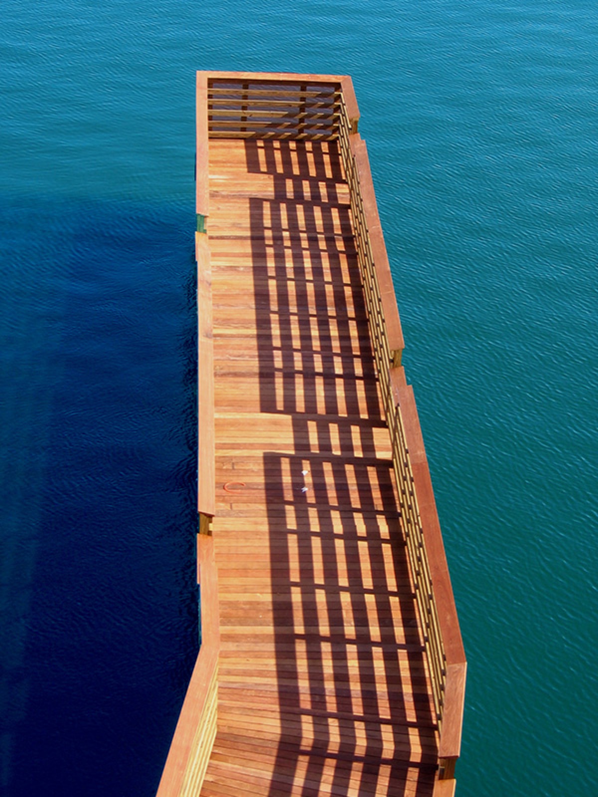 Tropical hardwood dock deck over coastal water