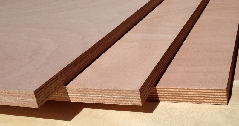 Stack of premium teak lumber boards showing consistent golden-brown heartwood color and tight grain pattern typical of high-grade teak stock