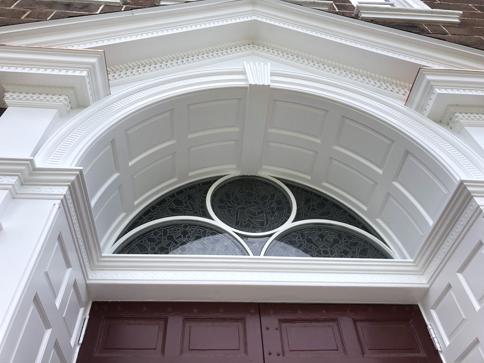 Arched entry with a fanlight set into the curved head