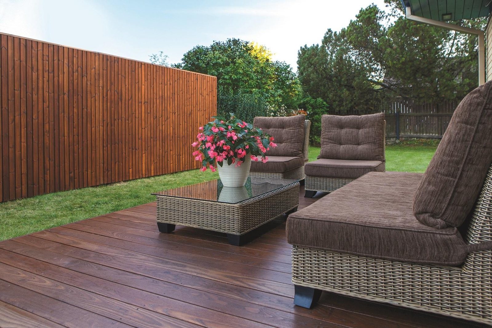 Deck seating set against a fence line