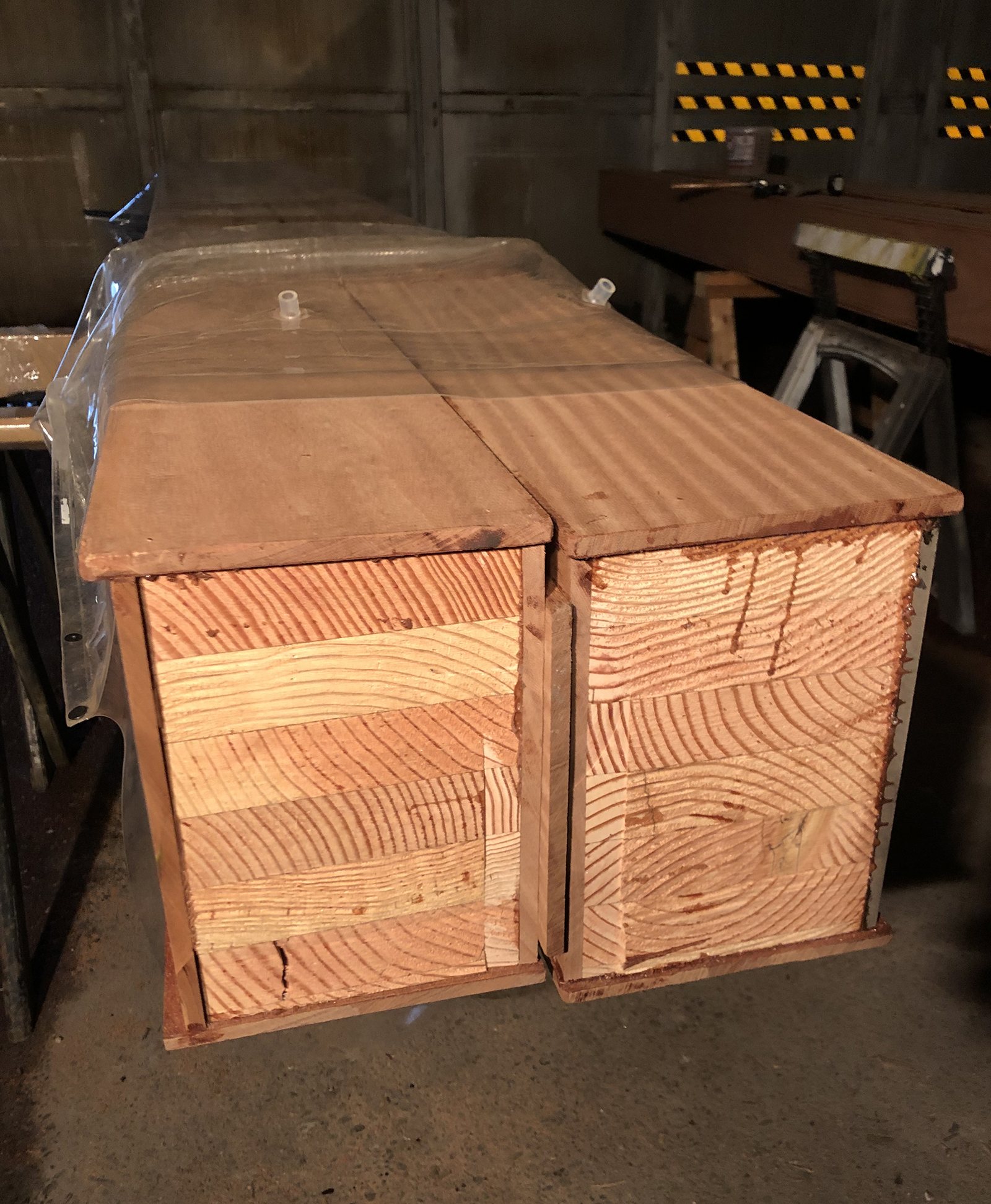 A box beam in the shop, open on one face, showing it is a hollow three sided shell