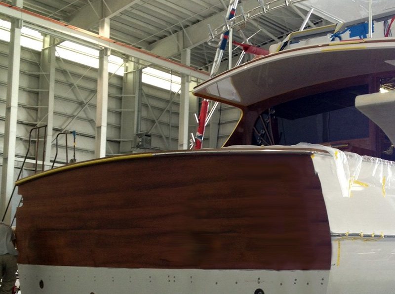 Varnished teak transom on a boat at a dock