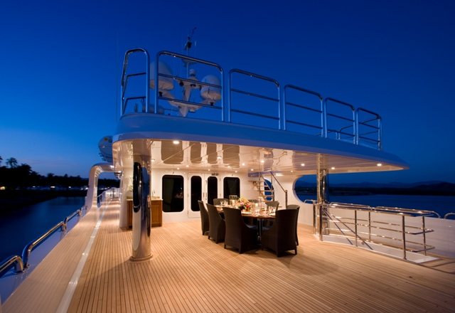 Teak yacht deck at dusk with the rail and structure