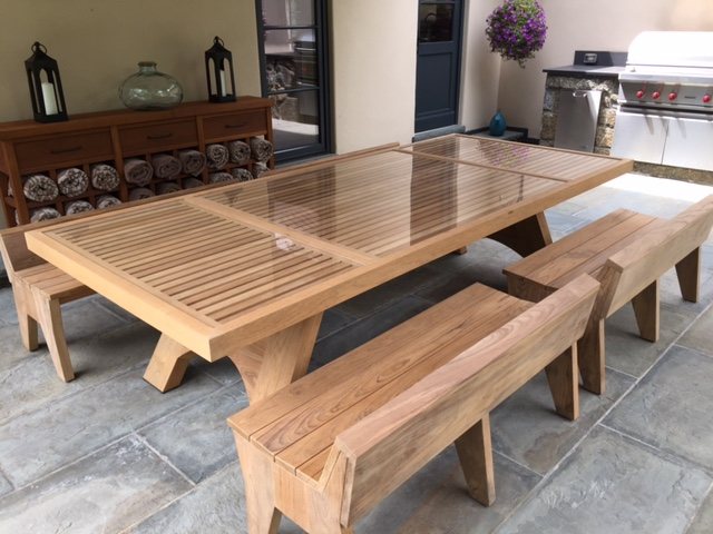 A teak outdoor table, legs out of 8/4 and a top built from staves in the 3 to 5 inch band