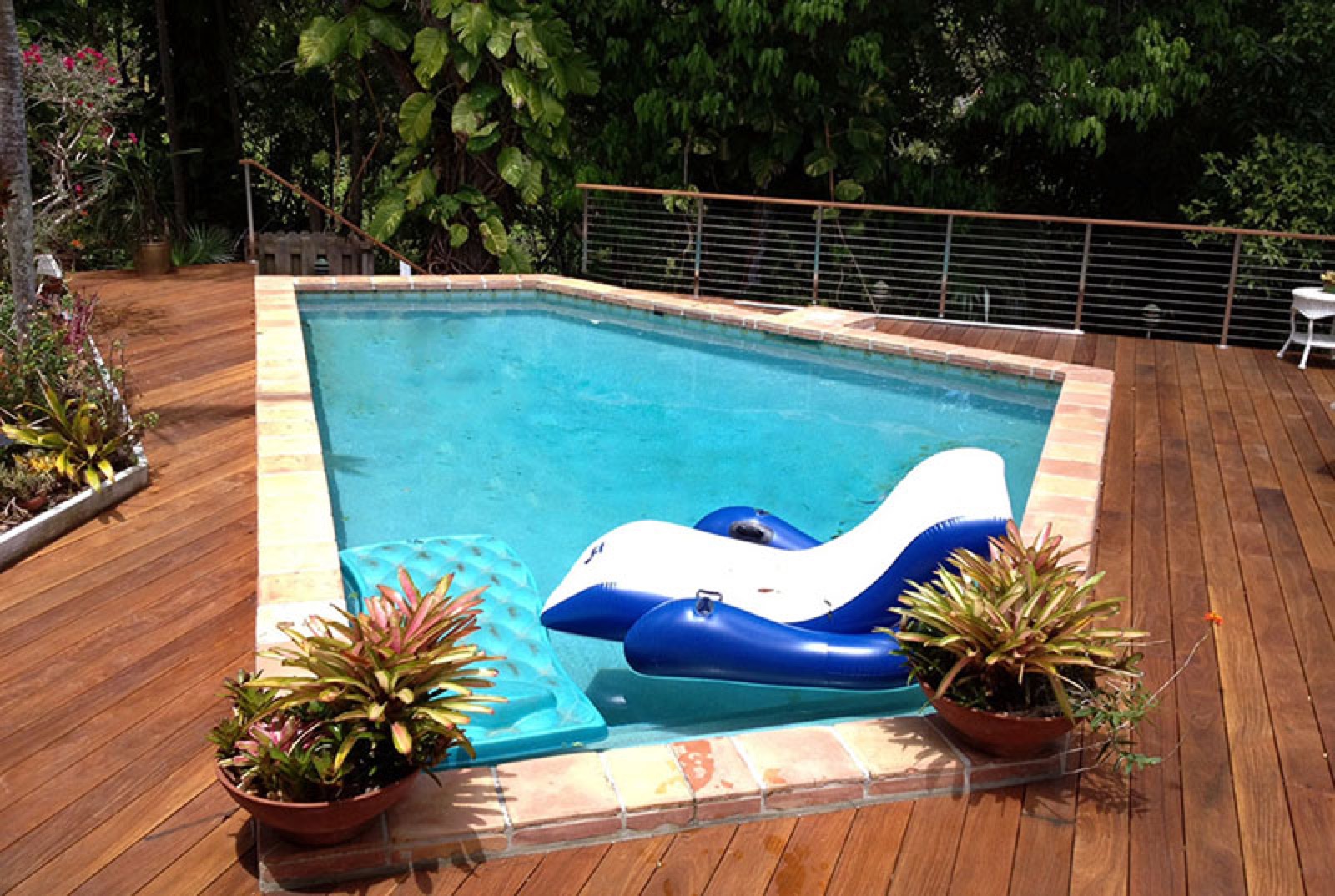 Tropical hardwood pool deck at a residence
