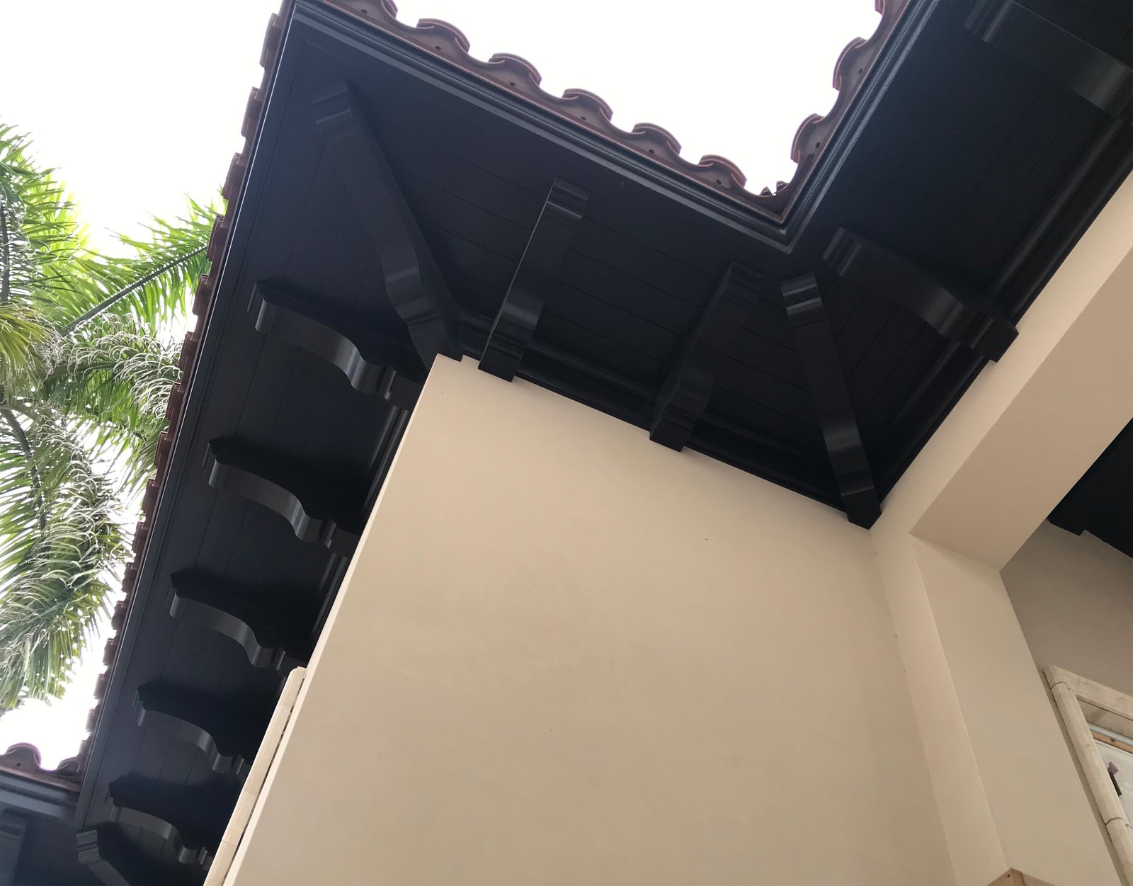 Milled rafter tails at the eave, the same exposure a dormer rake sees