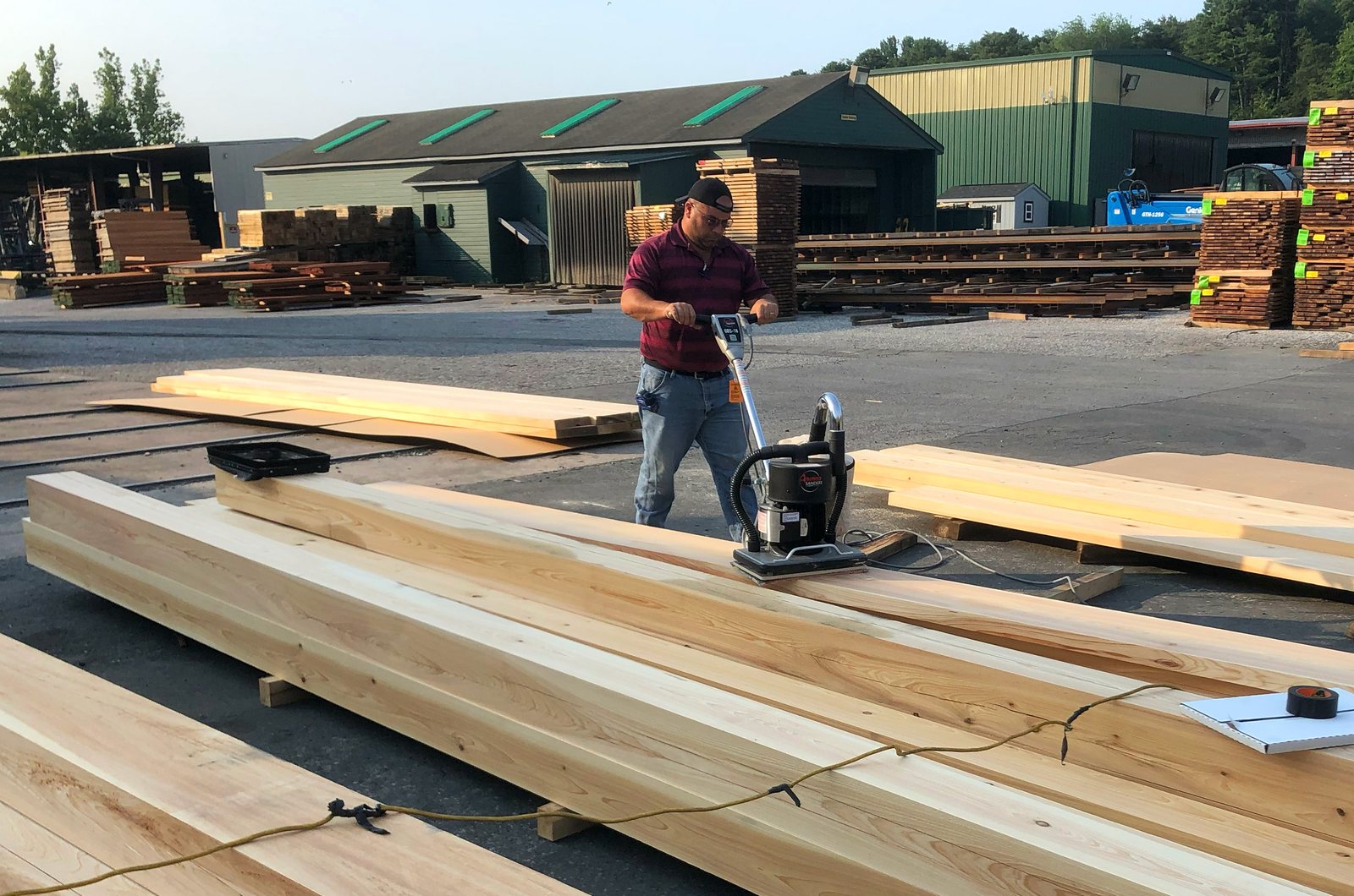 A long member being sanded flat, the surface a scarf has to disappear into