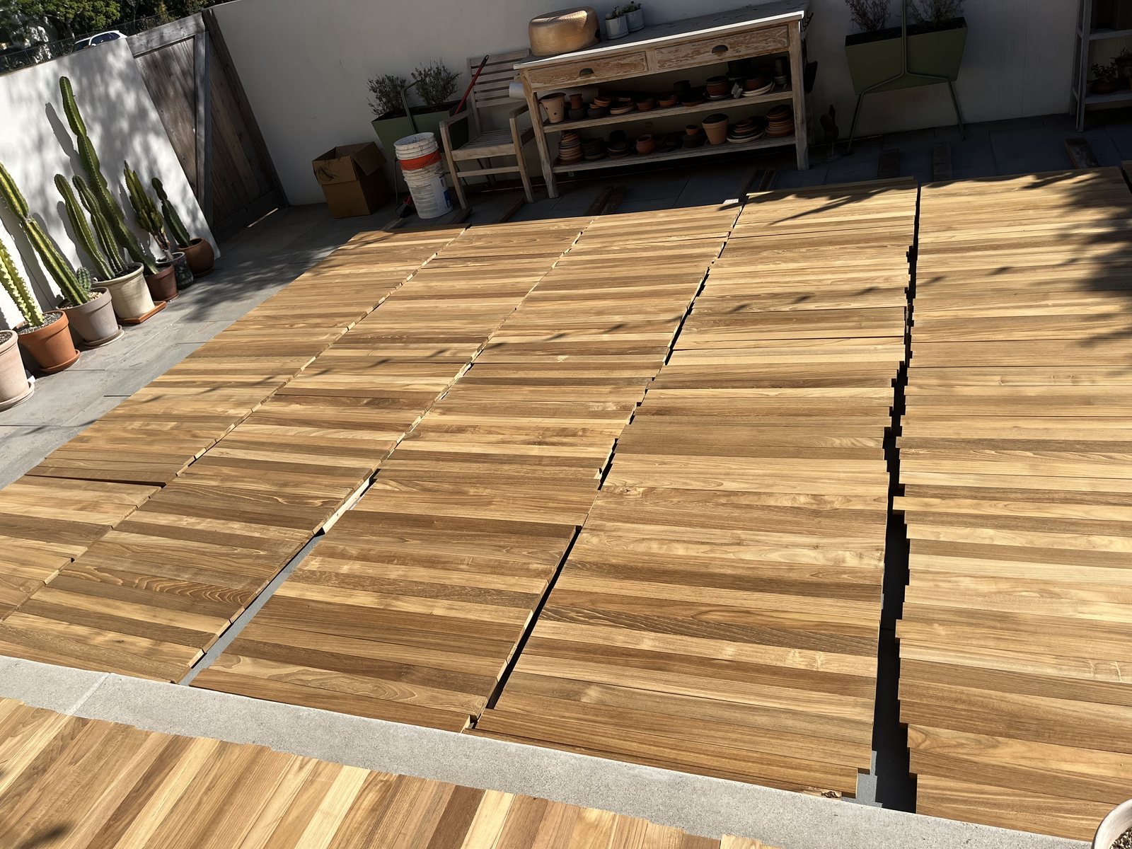 Teak laid out in the sun, which is the process a new board has to go through to catch up