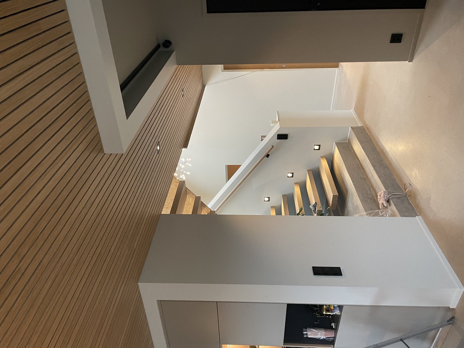 Modified Iroko cladding running up an interior stair wall