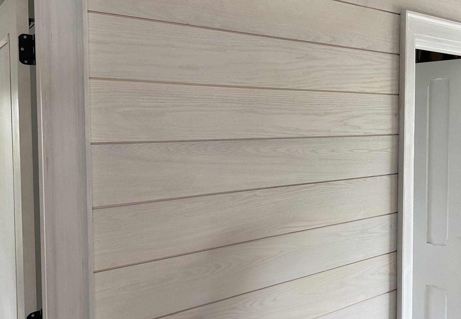 Wainscot and trim carrying the lower wall where an entry takes daily contact