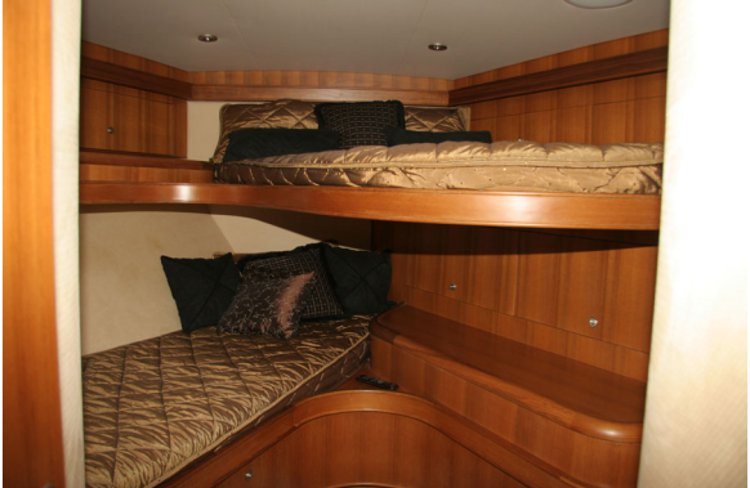 Built-in berth with shelving and a rail along the edge