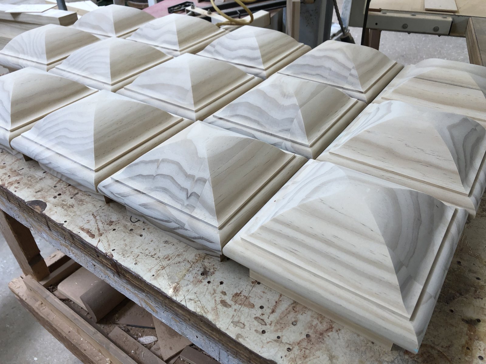 Post caps milled to close the top of a wrapped column
