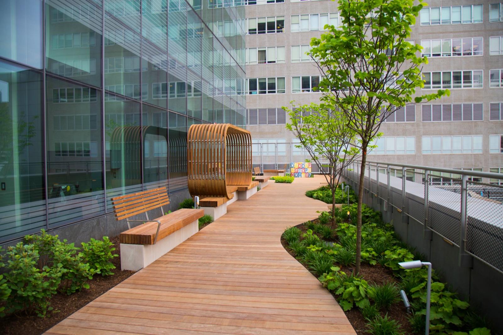 Rooftop tropical hardwood deck over an occupied building
