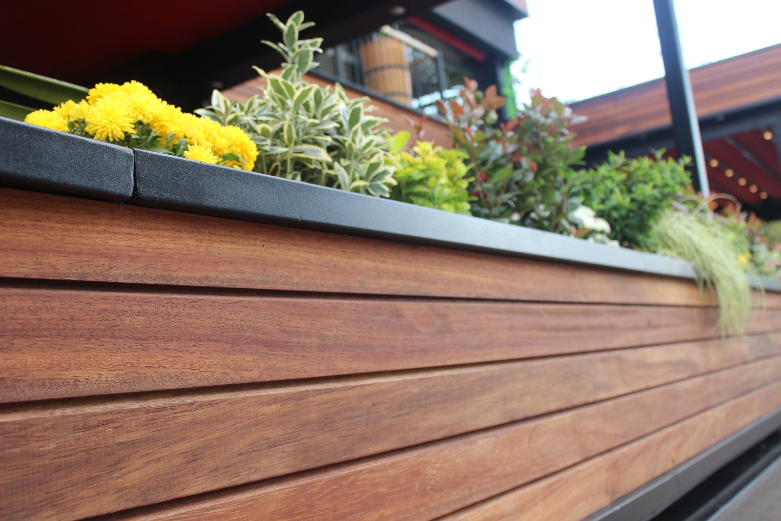 Planter boxes and decking meeting on a terrace