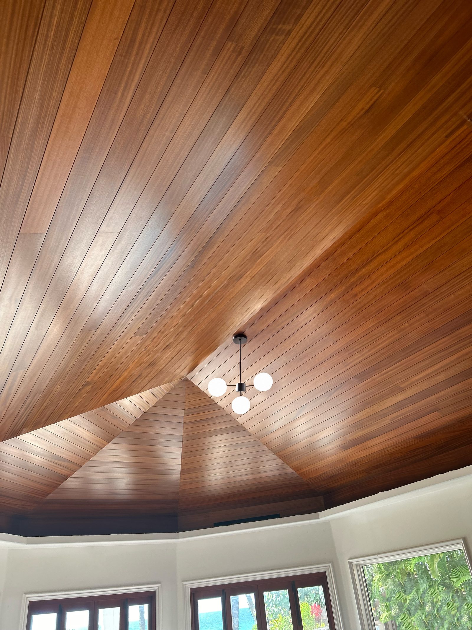 Sapele tongue and groove ceiling meeting at a shaped edge