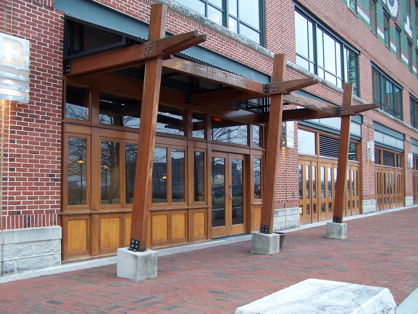 African Mahogany storefront trim running against masonry
