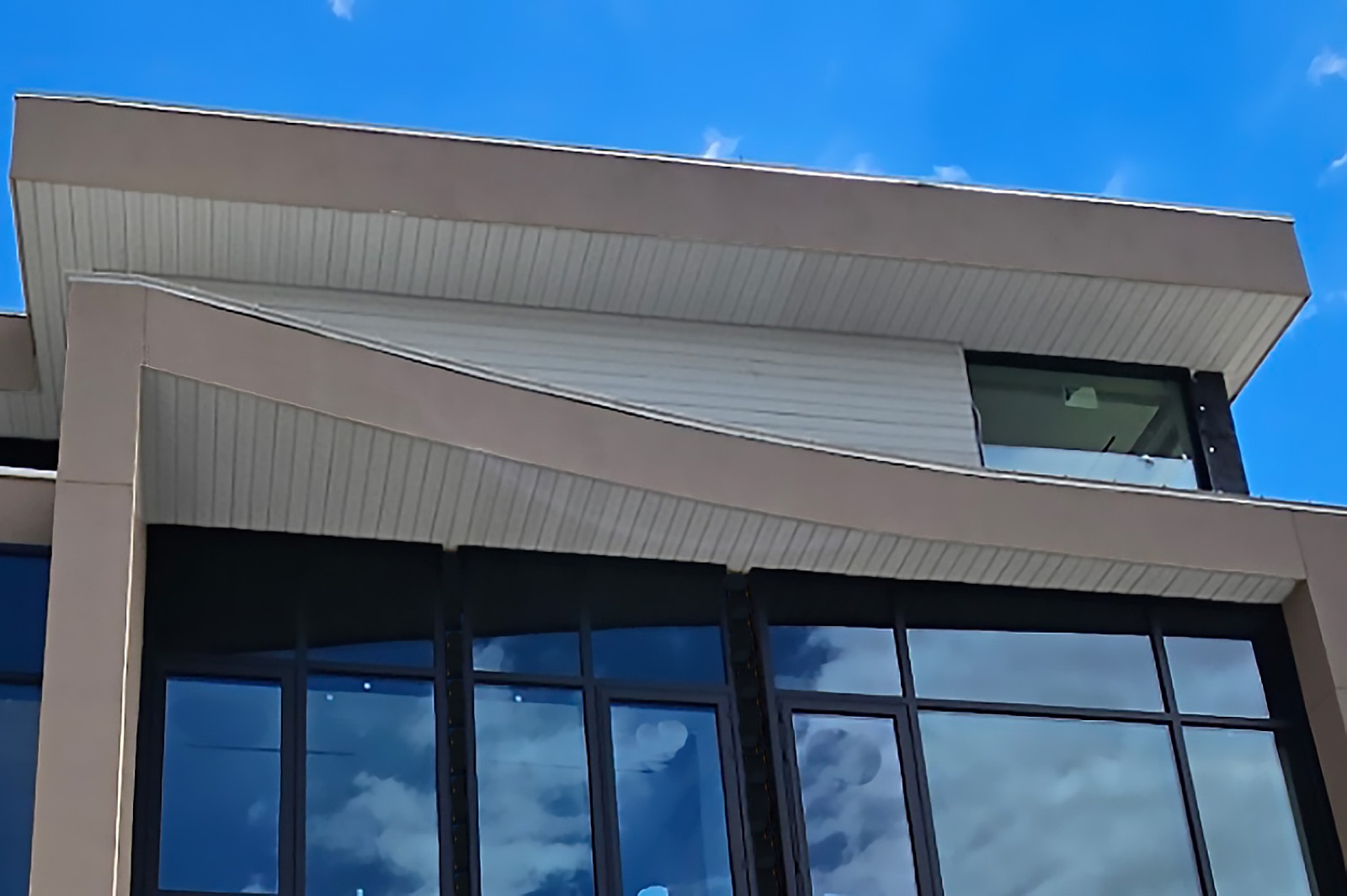 Milled soffit wrapping the eave of a modern building