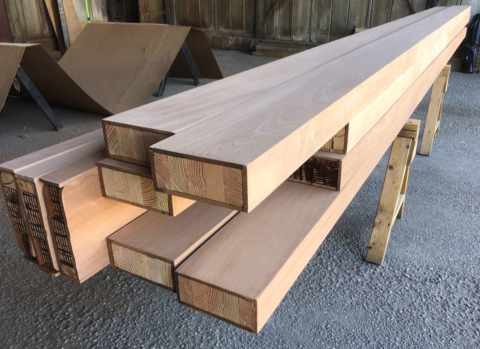 Box beam sections stacked before installation, showing the hollow interior