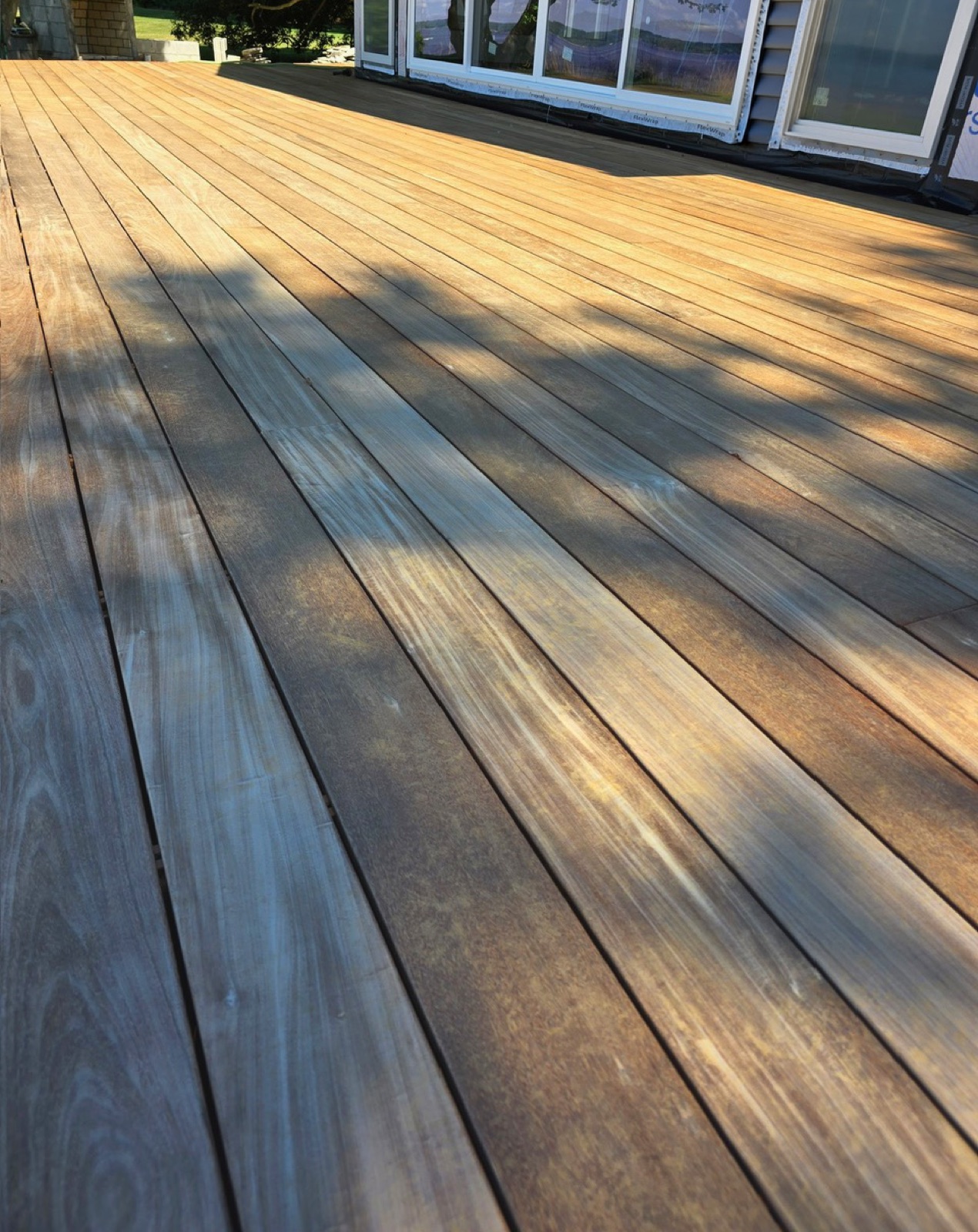 Weathered tropical hardwood deck surface left unfinished