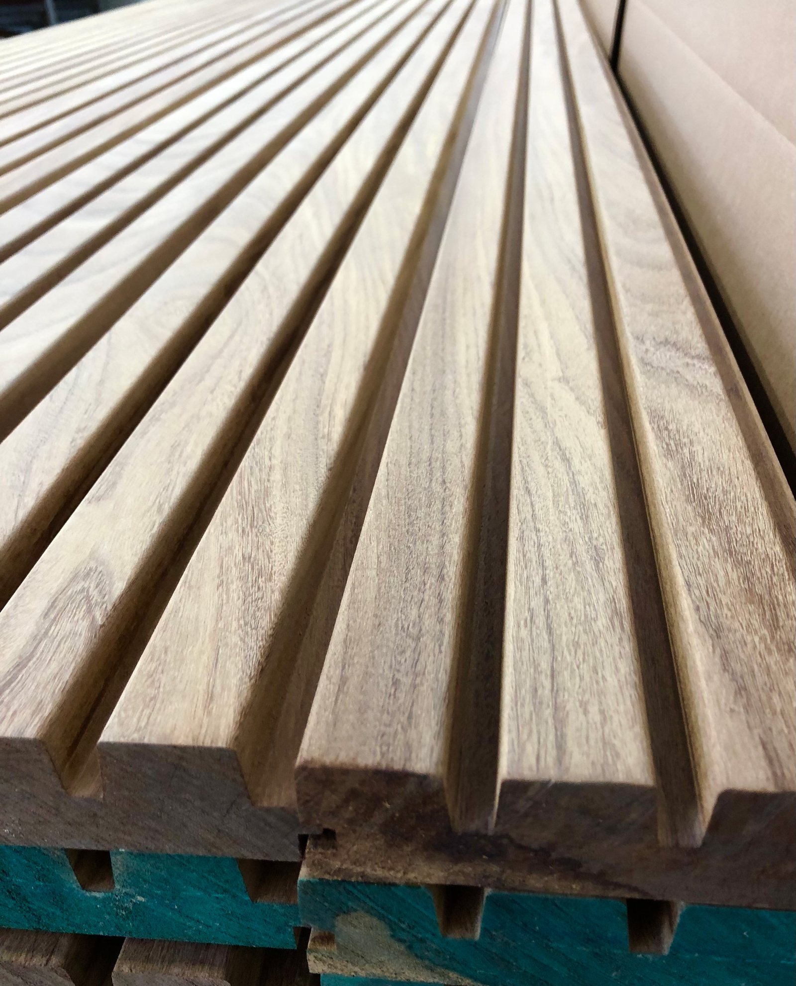 Milled fluted stock stacked in the shop, showing the profile and the land between flutes