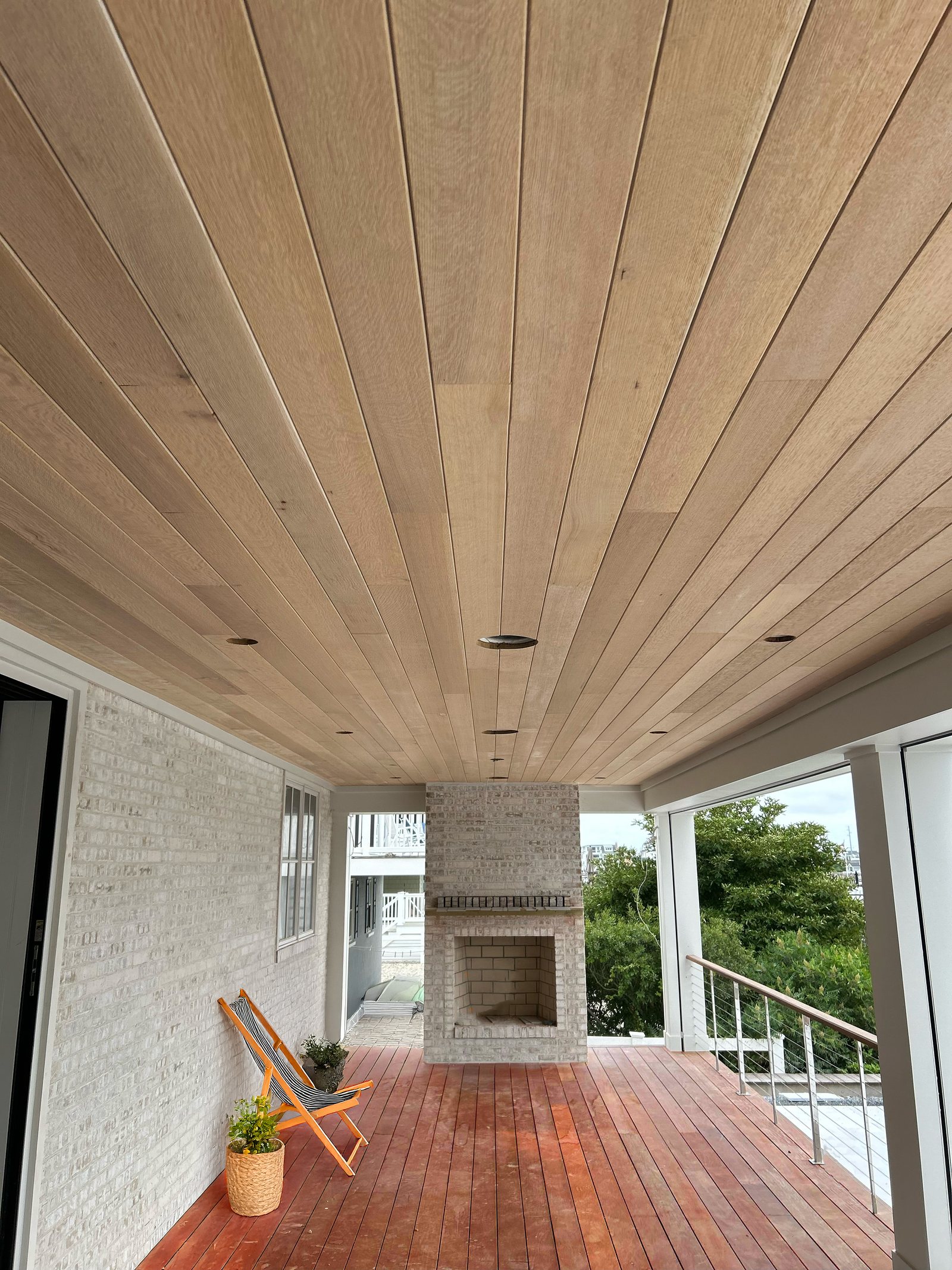 Tongue and groove porch ceiling boards running the length of a covered porch