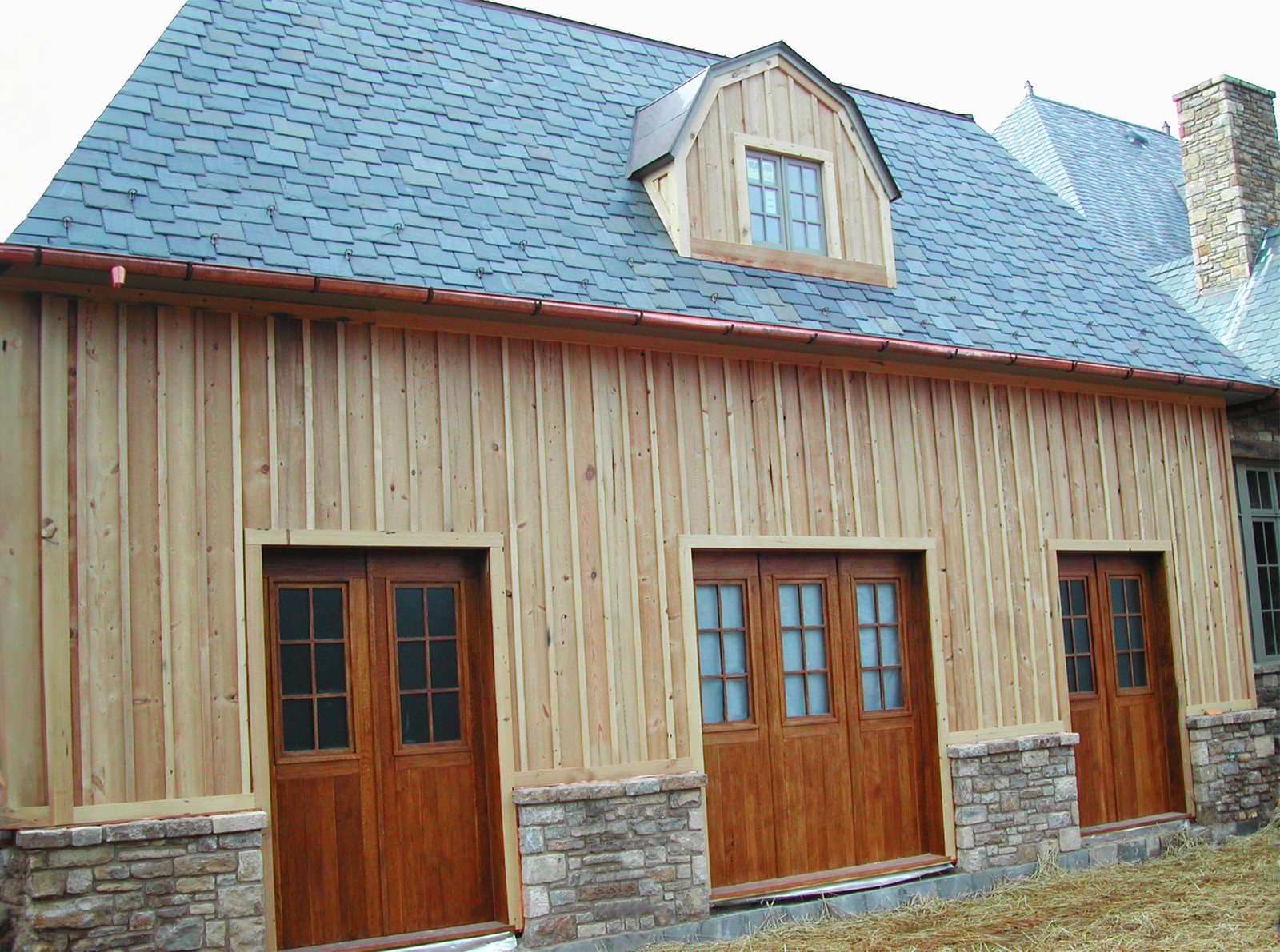 Cedar siding and mahogany doors run as one package across an elevation