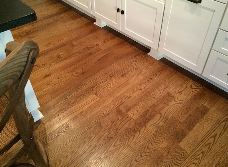 Ash flooring boards laid out across a finished room